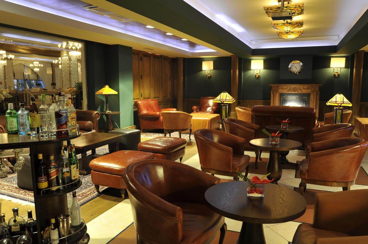 Leather tub chairs in a traditionally decorated bar at Kempinski Hotel The Dome