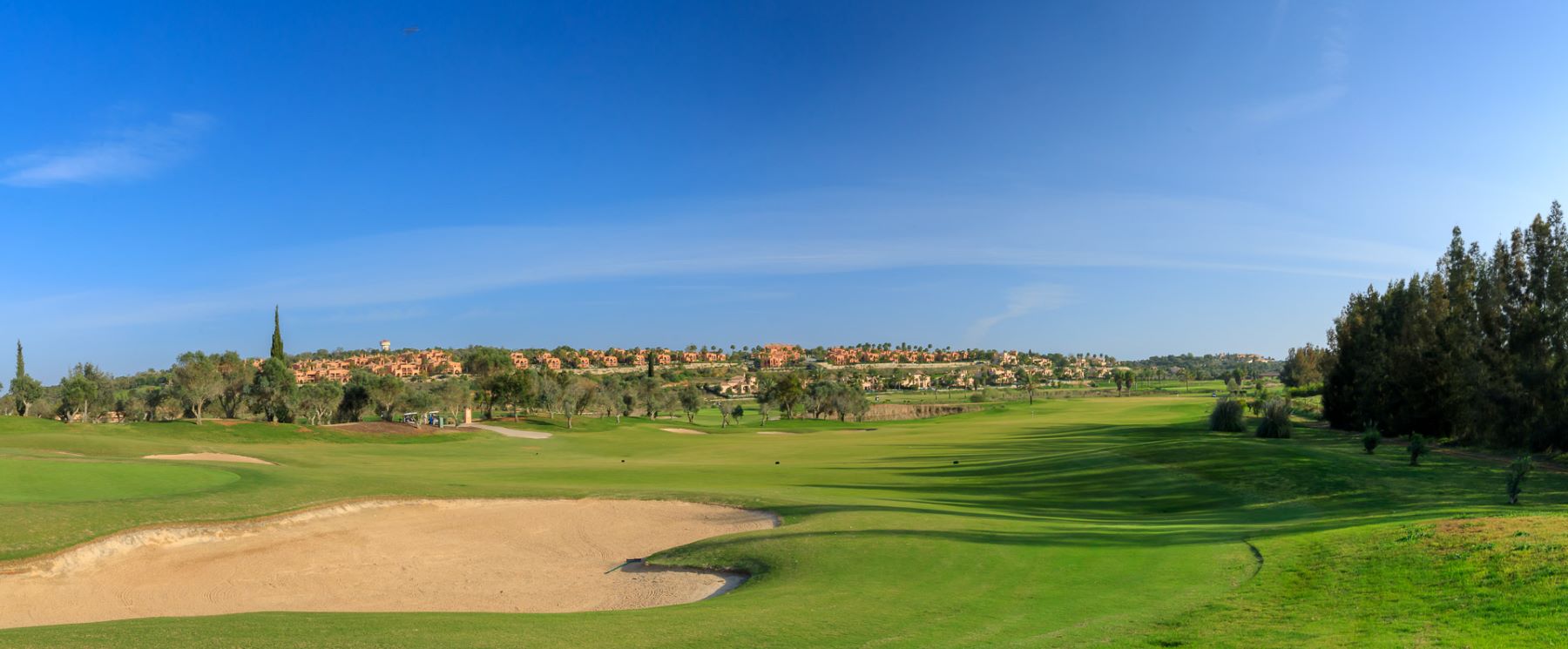 Villas and apartments in the distance of the fairways at Amendoeira Golf Resort