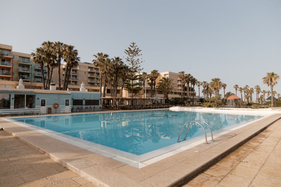 Swimming pool with trees overhead at Pestana Viking Hotel