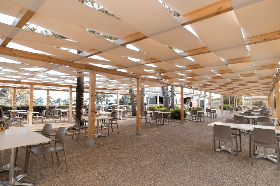Table and chairs in the restaurant with cover overhead at Pestana Viking Hotel