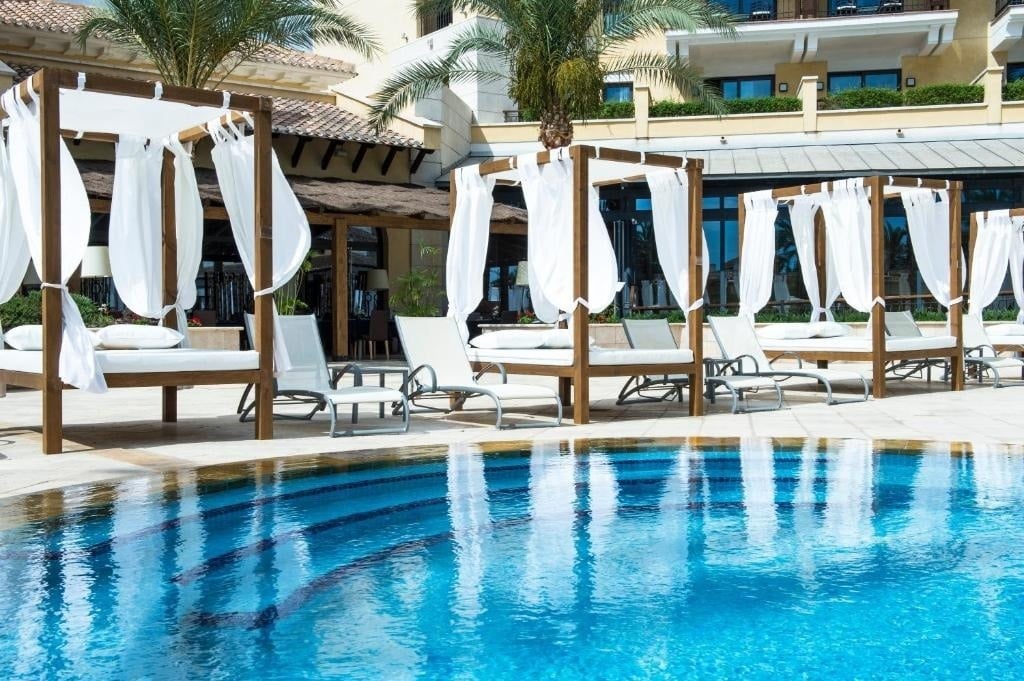 Outdoor bali beds around the swimming pool at Ona Mar Menor Golf Spa & Resort