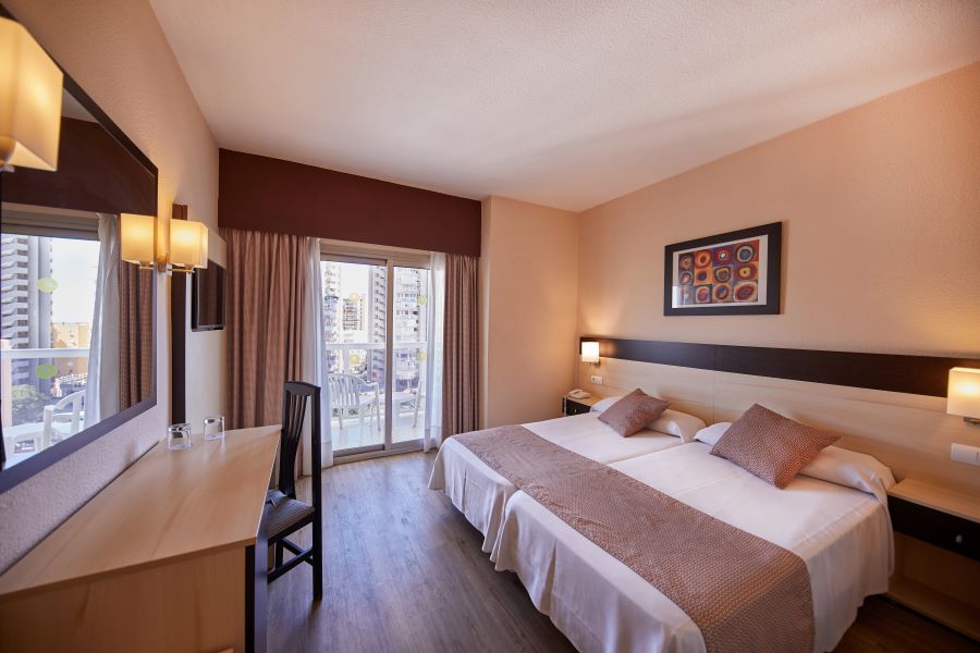 Bedroom at Sandos Griego Hotel with double bed, desk and balcony