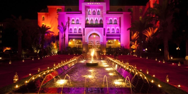 Hotel Sofitel Marrakech Lounge And Spa at night with illuminated fountains and water feature