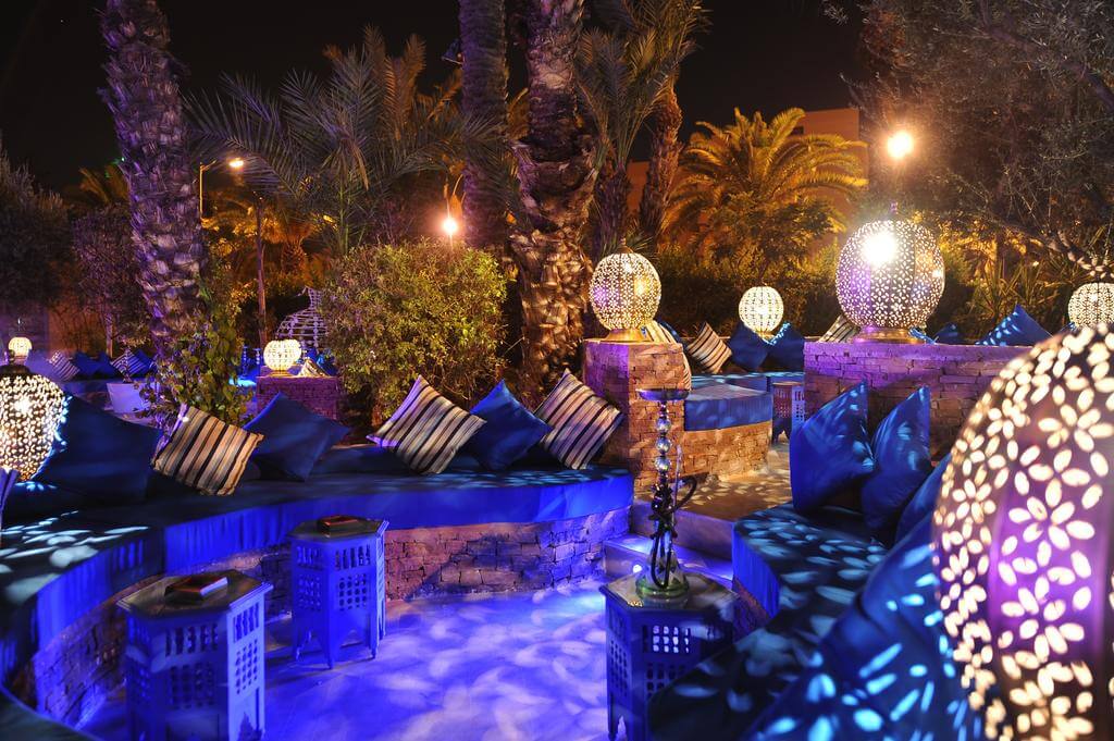 Outdoor seating at Hotel Sofitel Marrakech Lounge And Spa with lights and shisha pipe