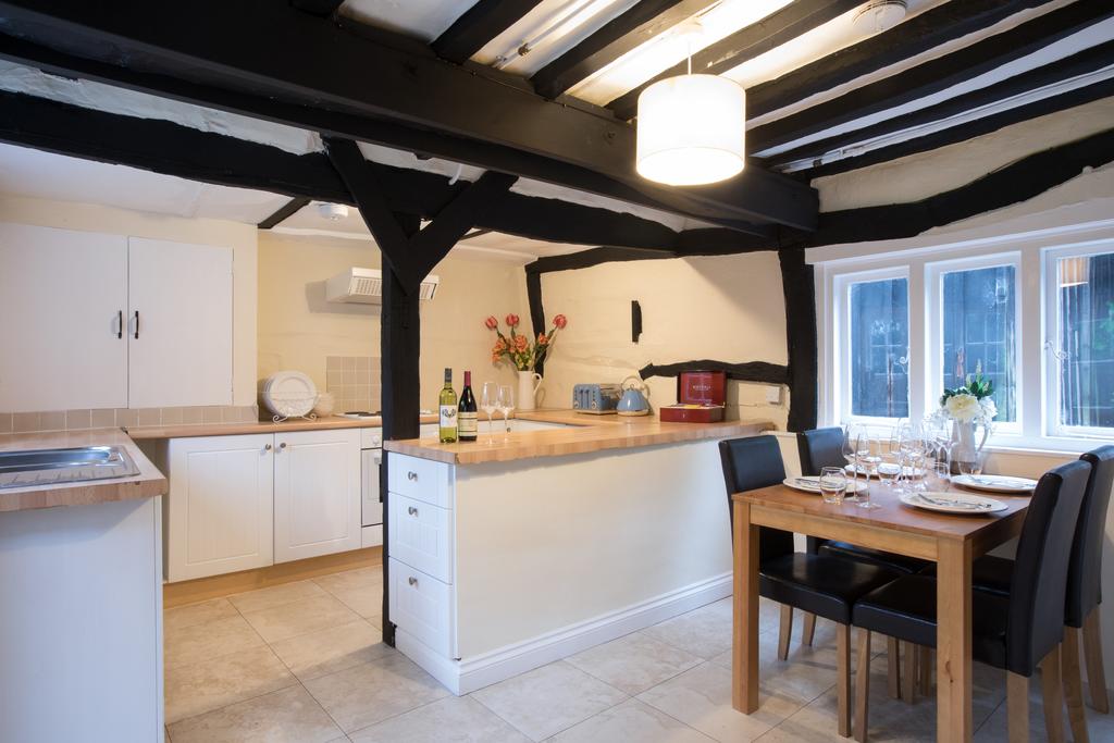 Wooden beamed kitchen with dining table at Mannings Heath Golf & Wine Estate