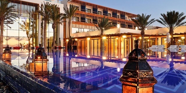 Sofitel Essaouira Mogador Golf And Spa at night, overlooking the swimming pool and palm trees