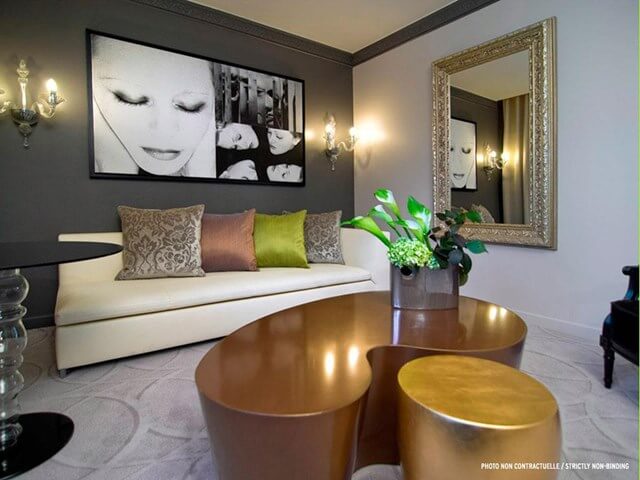 Sofitel Essaouira Mogador Golf And Spa lobby area with sofa, silver framed mirror on wall, and art on the wall