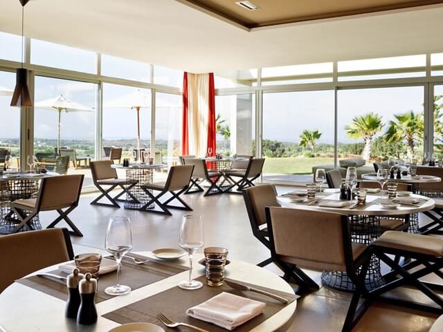 Restaurant at Sofitel Essaouira Mogador Golf And Spa with brown chairs and tables set for guests with views of the golf course