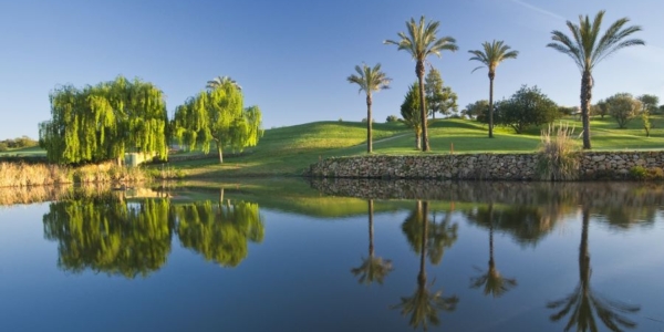 Pestana Gramacho Golf Course in the Algarve with lake and palm trees