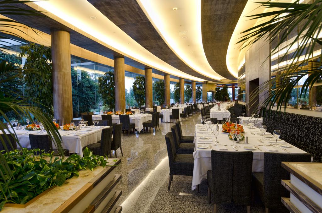 Restaurant with tables set for guests at Gloria Serenity Resort