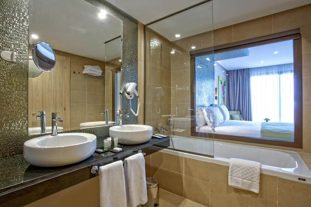 Be Live Collection Marrakech Adults Only bathroom with twin sinks, shower over bath, bath tun, hairdryer and mirror