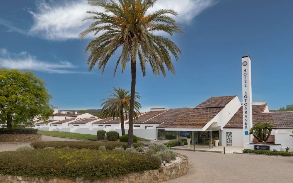 Entrance to Hotel Encinar De Sotogrande with palm tree in front