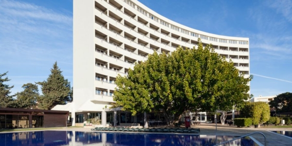 Exterior of Dom Pedro Vilamoura Hotel in the Algarve with swimming pool in front, close to the famous marina