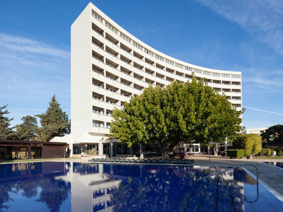 Exterior of Dom Pedro Vilamoura Hotel in the Algarve with swimming pool in front, close to the famous marina