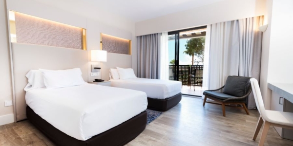 Bedroom with twin beds, desk and chair at DoubleTree by Hilton Islantilla Beach Golf Resort