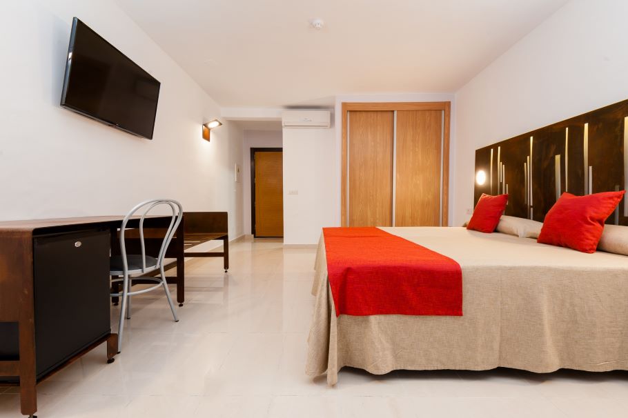 Bedroom with television on the wall at Kn Columbus Aparthotel