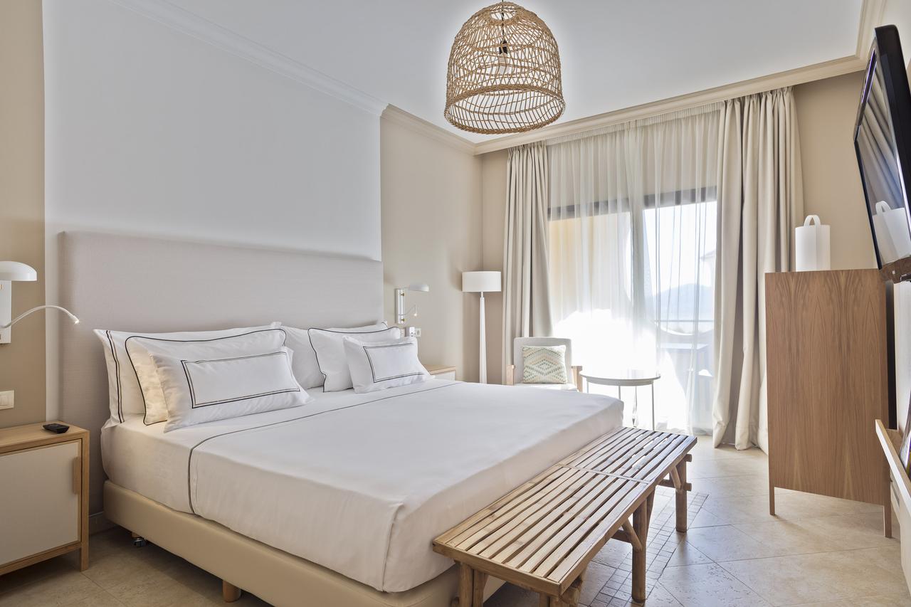 Bedroom at Melia Villaitana Golf Resort with white linen bed and flat screen television