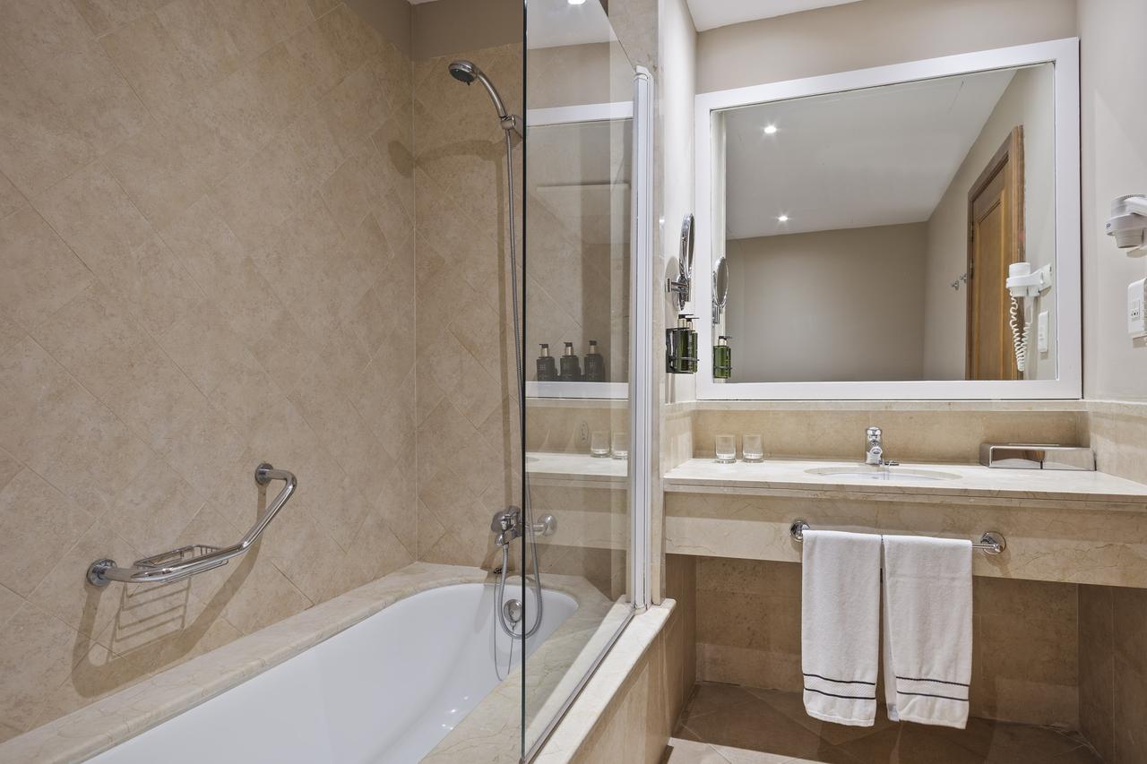 Bathroom at Melia Villaitana Golf Resort with shower, sink and hair dryer