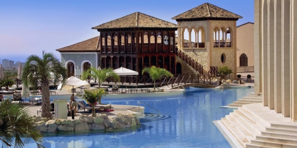 Swimming pool area with sun loungers at Melia Villaitana Golf Resort Benidorm