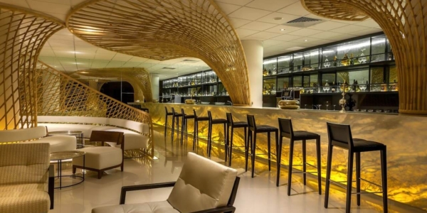 IIlluminated bar with bar stools at Hyatt Place Taghazout Bay