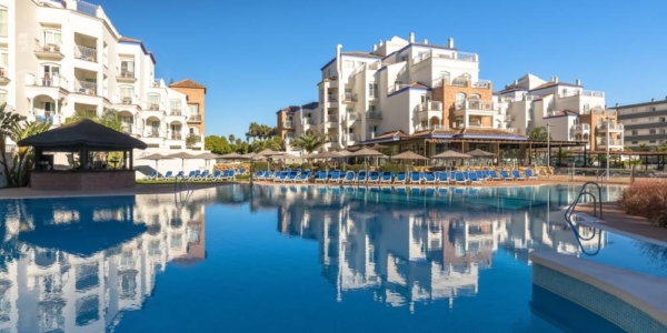 Swimming pool with sun loungers at Occidental Torremolinos Playa