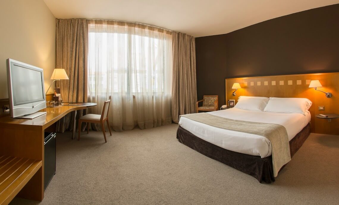 Bedroom at Hotel Carlemany Girona with double bed and flat screen television
