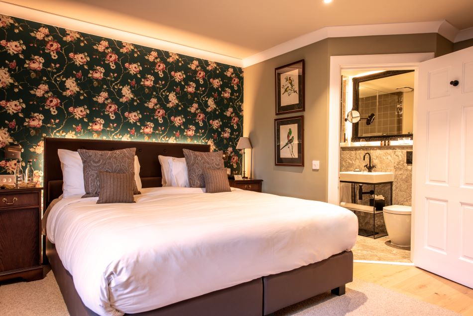 Double bedroom in Roxburghe Hotel And Golf Course with animal print wall paper and bathroom