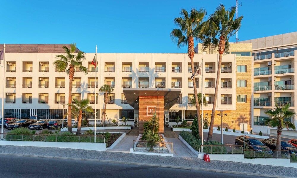 Entrance of AP Maria Nova Lounge Hotel with palm trees