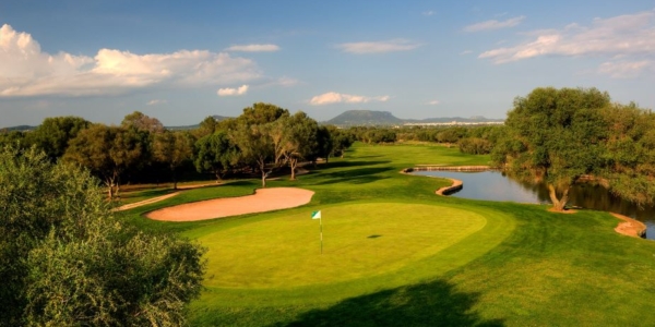 Green with flag and river on the right at Son Antem East Golf Course in Mallorca