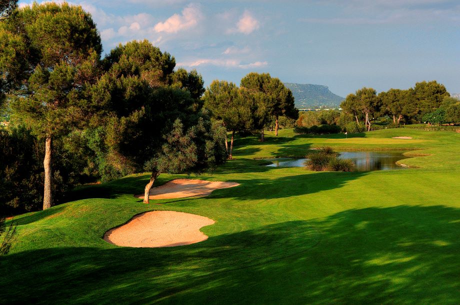 Sand bunker with green trees surrounding at Son Antem West Golf Course