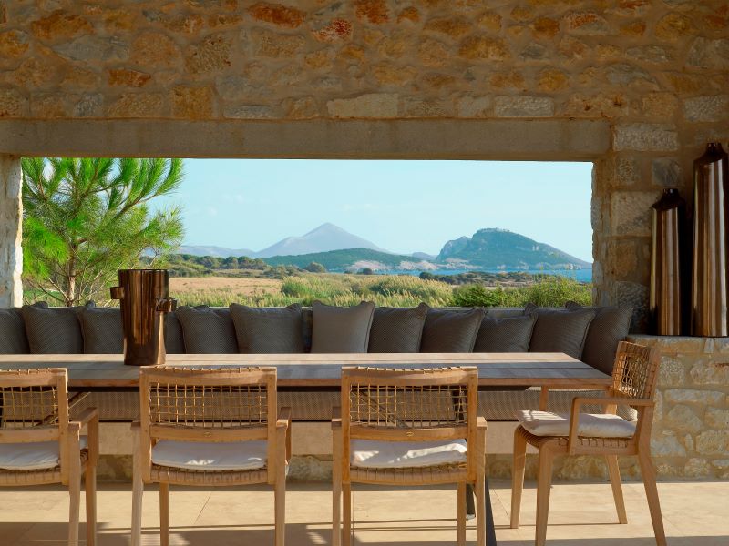Table with chairs and view at The Ramanos, A Luxury Collection Resort in Costa Navarino