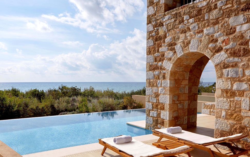 Swimming pool with sun loungers at The Westin Resort Costa Navarino in Greece