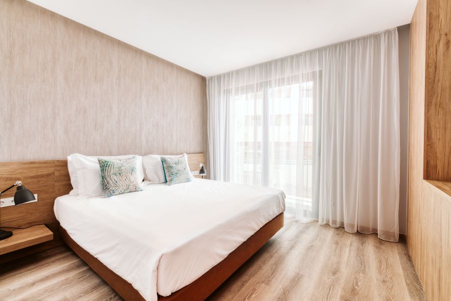 Bedroom at Vila Baleira Funchal with window onto street view