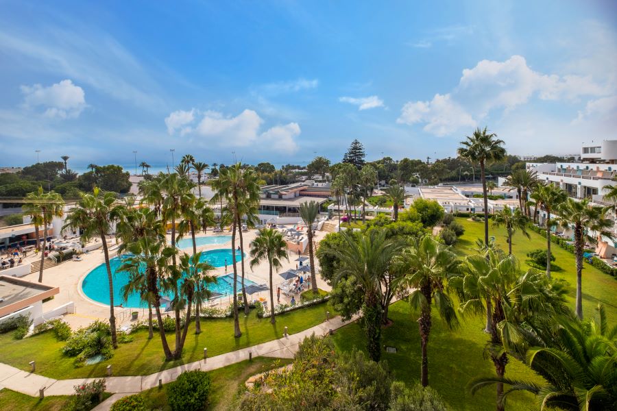 Agadir Allegro resort in Morocco with palm trees surrounding the swimming pool