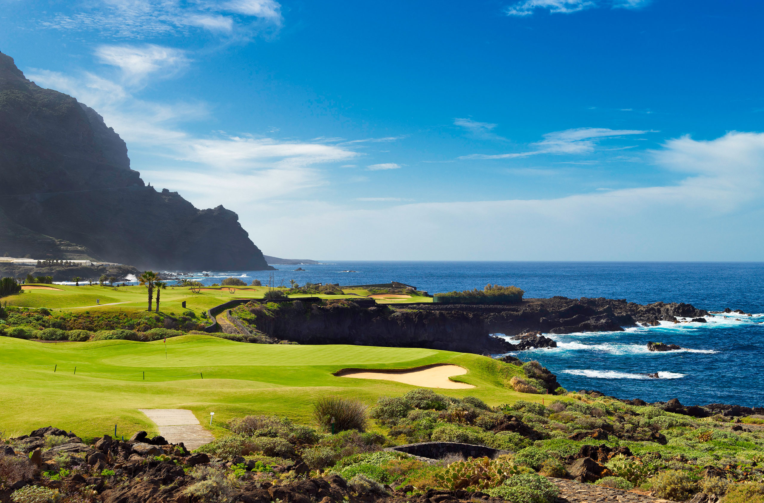 Melia Haciende Del Conde Golf Course with scenic clifftop backdrop