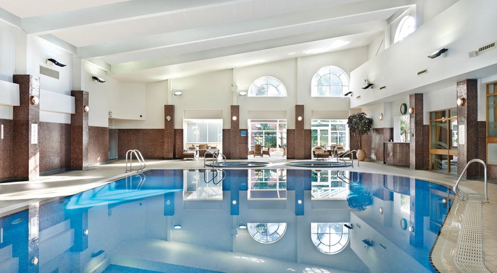 Indoor heated swimming pool and seating area in the background at The Belfry
