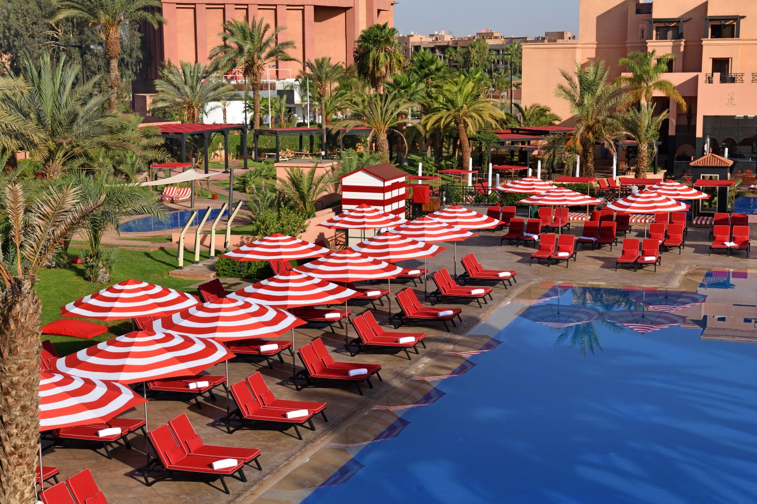 Swimming pool with sun loungers at Movenpick Hotel Mansour Eddahbi Marrakech