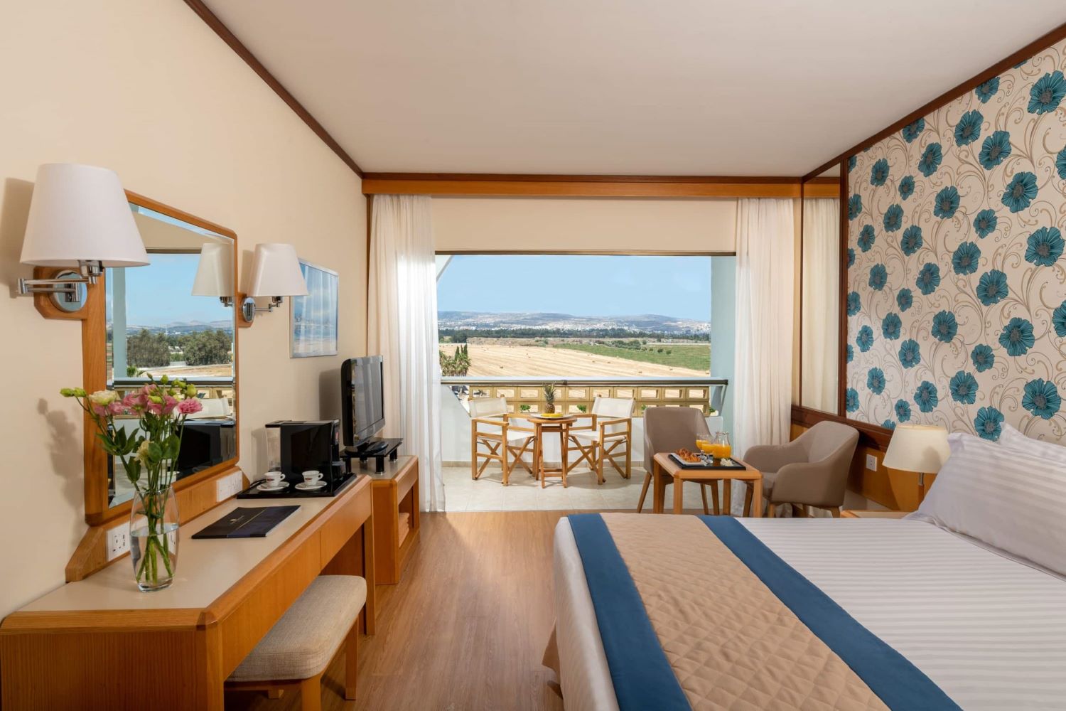 Bedroom with balcony at Constantinou Bros Athena Royal Beach Hotel in Paphos