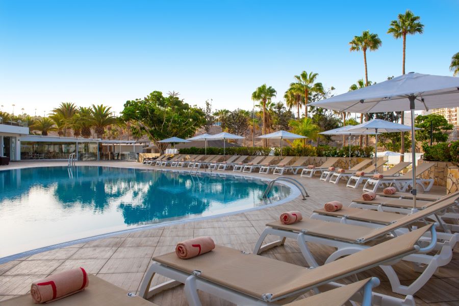 Swimming pool with sun loungers at Ole Tropical Tenerife, an adults only hotel