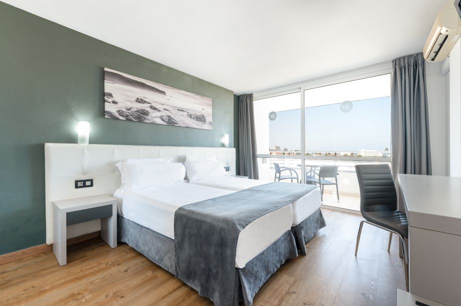 Bedroom at Ole Tropical Tenerife with twin beds and green painted walls