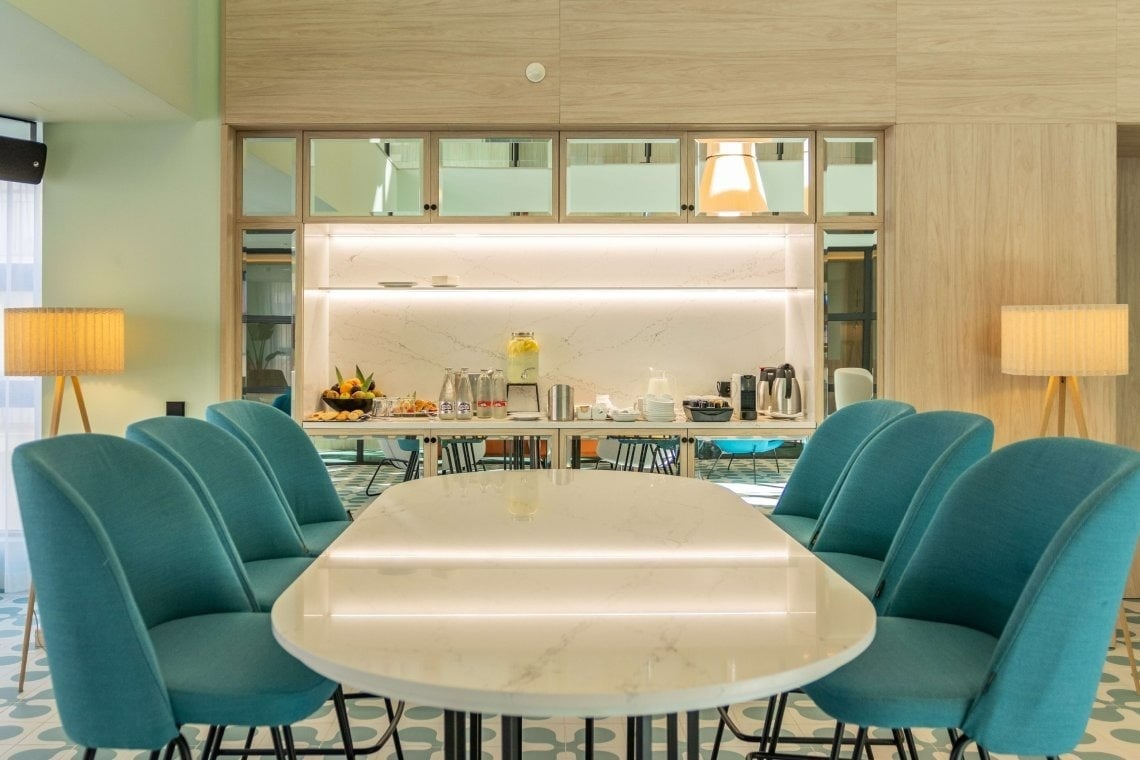 Green chairs at the table at Hotel Angel Fuengirola