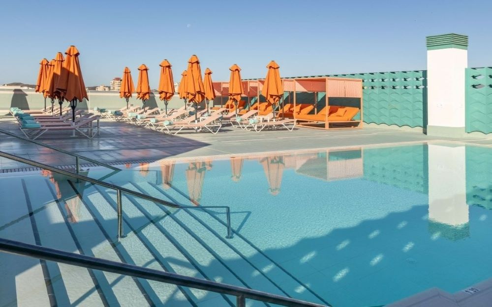 Orange parasols and sun loungers on the rooftop at Hotel Angela