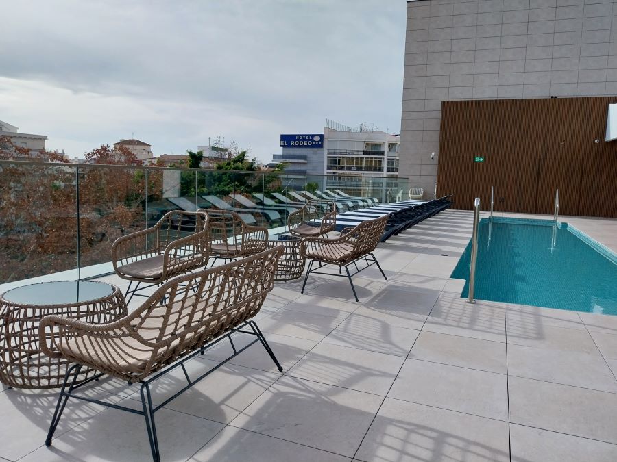 Chairs near swimming pool on rooftop at Obal Urban Hotel in Marbella