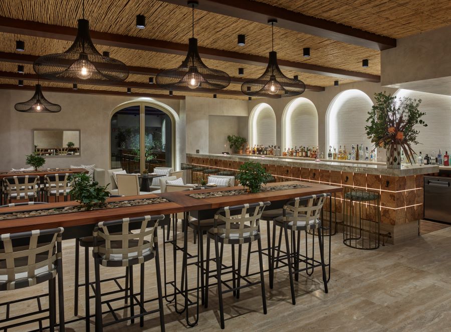 Restaurant with black stools and wooden table at Viceroy at Ombria Algarve