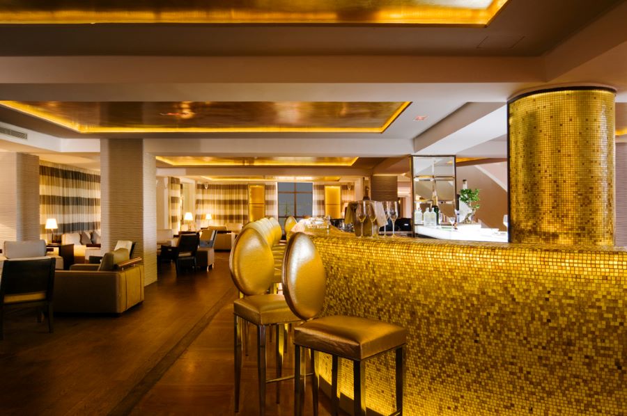 Bar with golf decor and stools at Pickalbatros Hotel Du Golf Palmeraie Marrakech