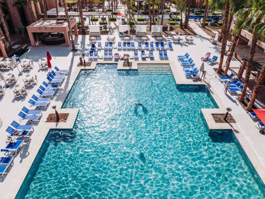 Sun shining off the water in the outdoor pool at Pickalbatros Hotel Du Golf Palmeraie Marrakech
