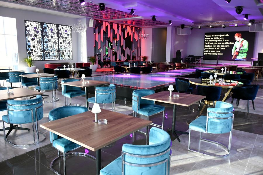 Blue chairs with purple lighting at Pickalbratros White Beach Taghazout Resort