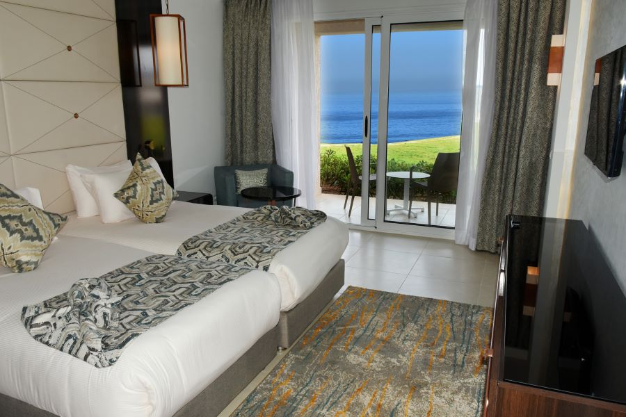 Twin beds in room and garden view at Pickalbratros White Beach Taghazout Resort