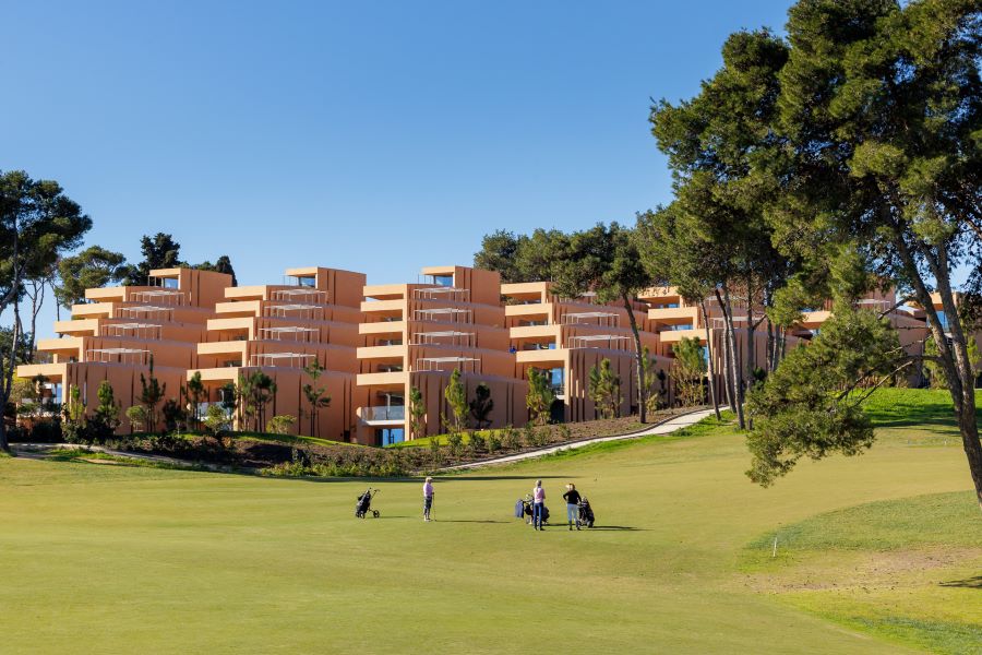 Golfers on the fairway in front of the property at Palmares Signature Apartments