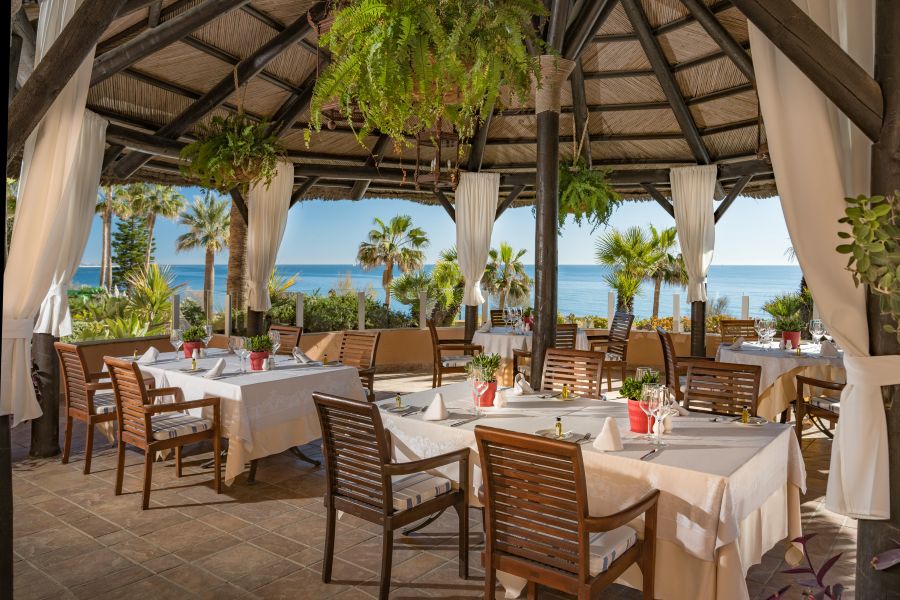 Restaurant on patio with roof overhead and sea views at Elba Estepona Gran Hotel & Thalasso Spa